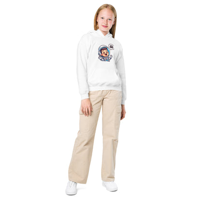 Youth wearing a white heavy blend space hoodie featuring a fun astronaut graphic with beige cargo pants