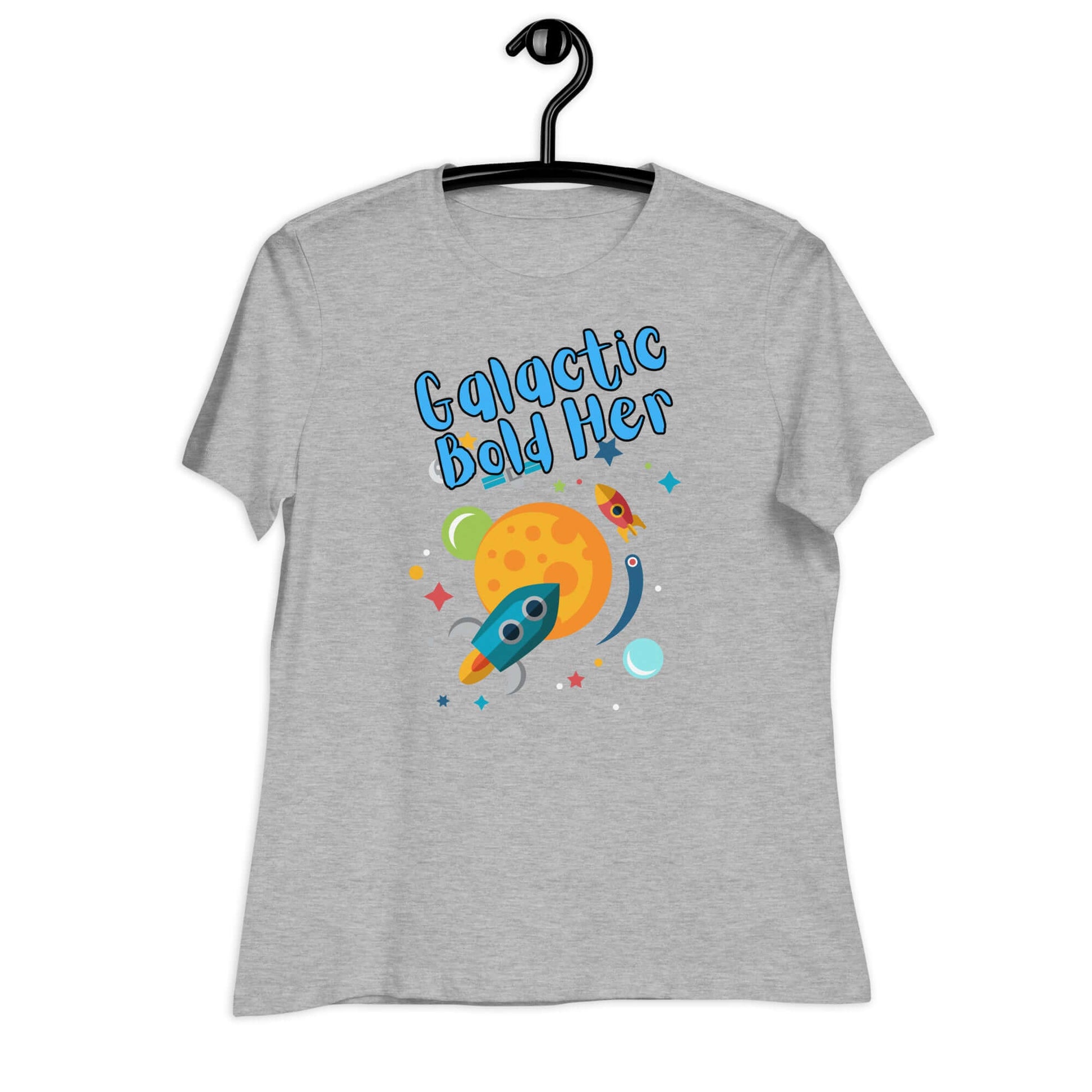 Galactic Bold Her graphic t-shirt on a hanger, featuring a rocket and planet design.