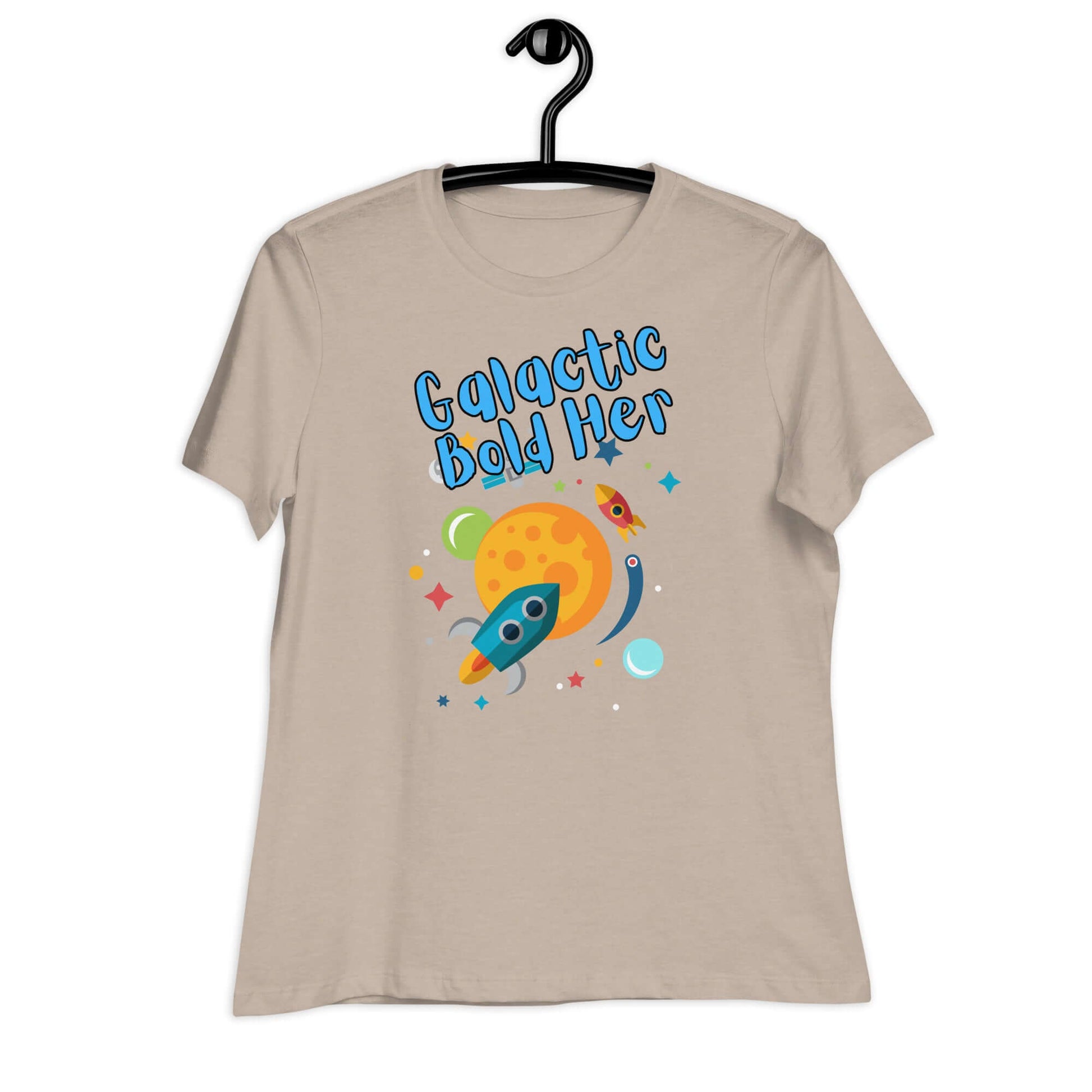 Galactic Bold Her graphic t-shirt for women featuring a colorful rocket and planet design on a beige background.