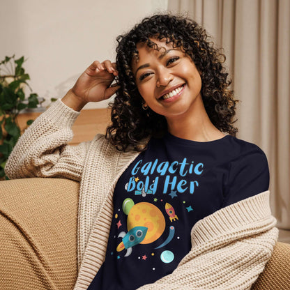 Woman wearing a navy blue t-shirt with 'Galactic Bold Her' design, smiling and cozy in a cardigan.
